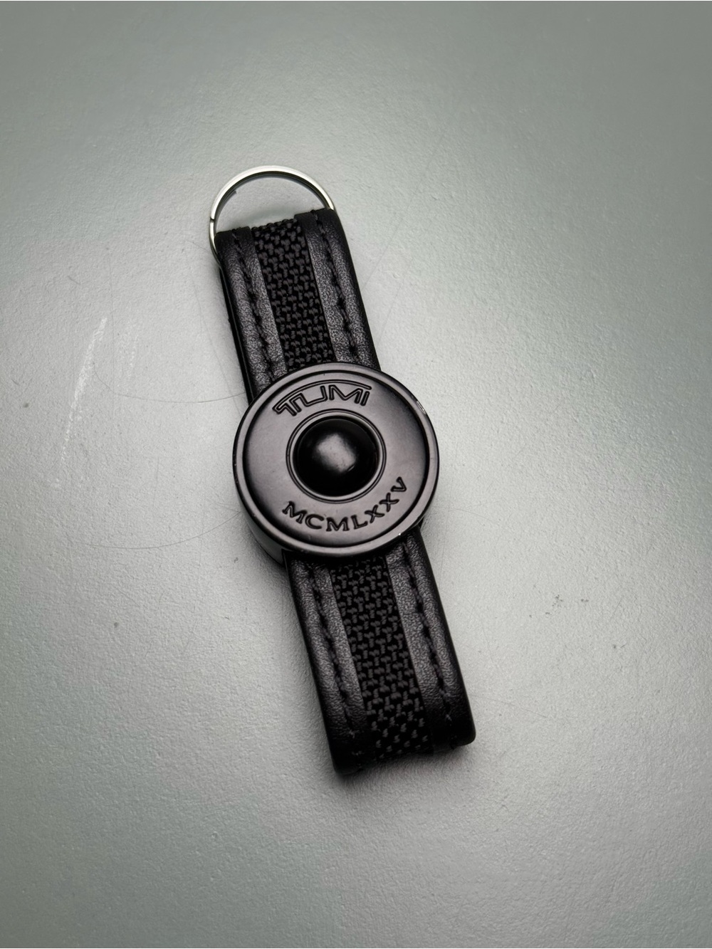 Tumi Black Leather & Ballistic Nylon Push Button Key Ring Fob with Matte Emblem